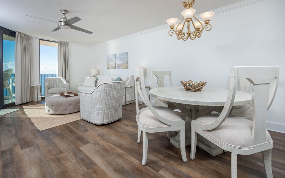 Relax in this airy living space featuring comfortable seating and a dining area, perfect for enjoying meals together