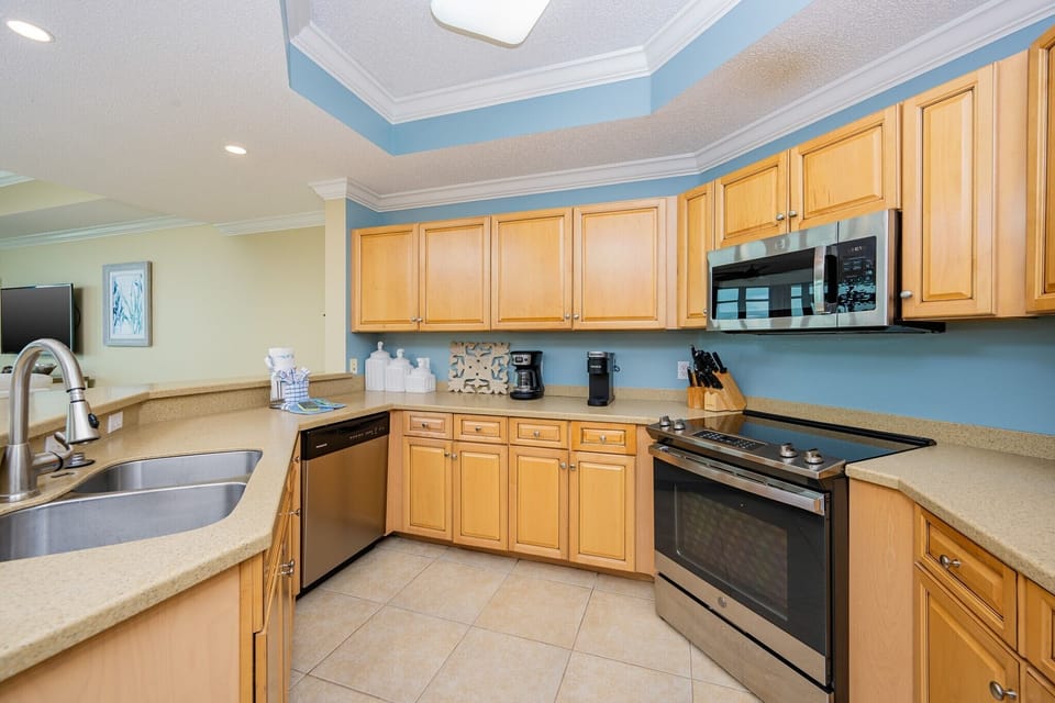 Craft delicious meals in the inviting kitchen, complete with sleek appliances and cozy coastal decor