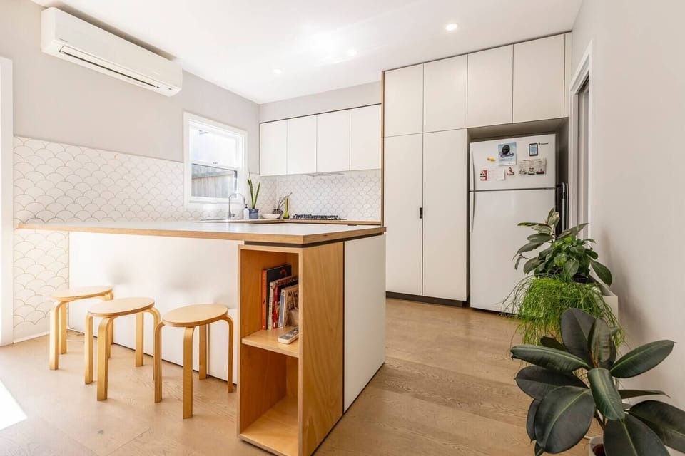 A breakfast bar provides casual seating for a quick bite to eat or chats with the cook.