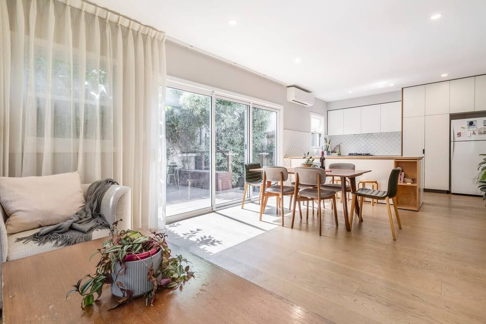 A seamless open plan is framed by large sliding doors, extending to the back deck and patio.