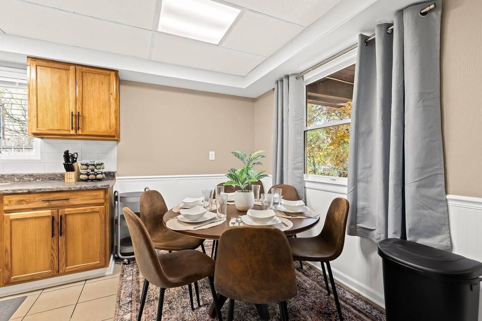 Delight in your meals in this sunny dining nook, framed by garden views and accented with warm wood finishes—perfect for both casual breakfasts and intimate dinners