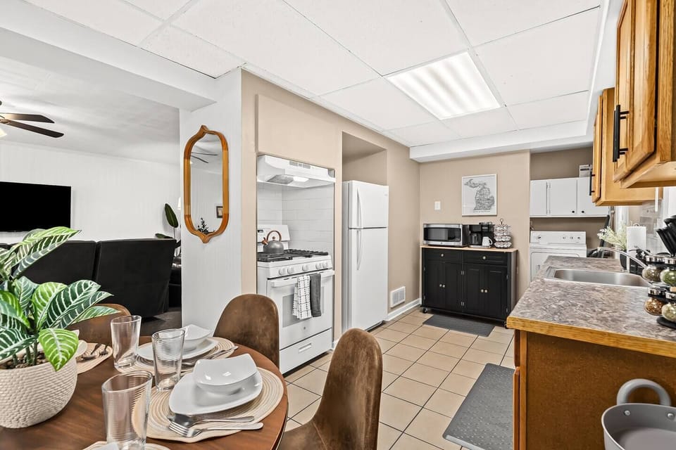 Experience the comfort of home in this well-lit dining space that effortlessly flows into a fully-equipped kitchen, ready for your culinary adventures
