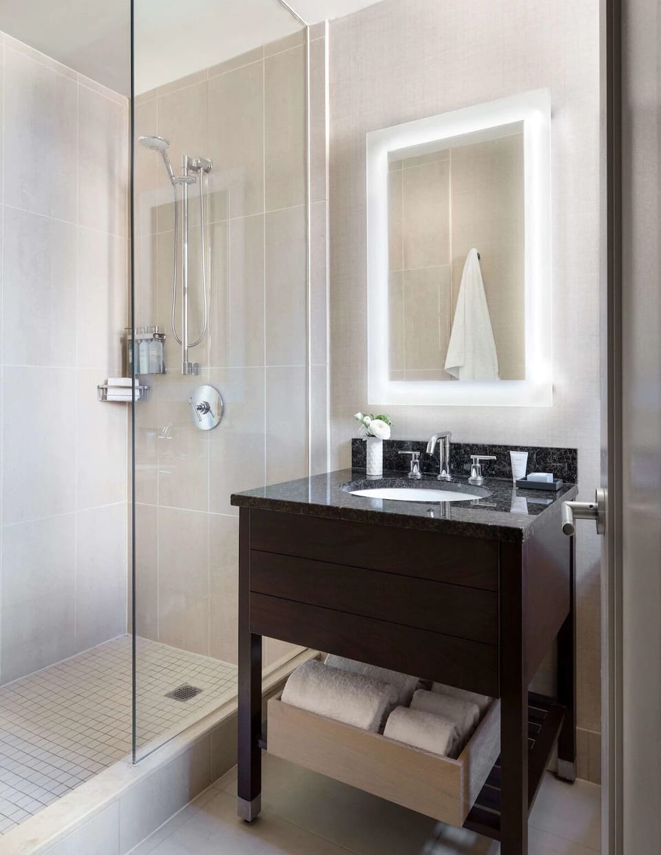 Refresh in a spotless glass shower with spa-bright vanity.
