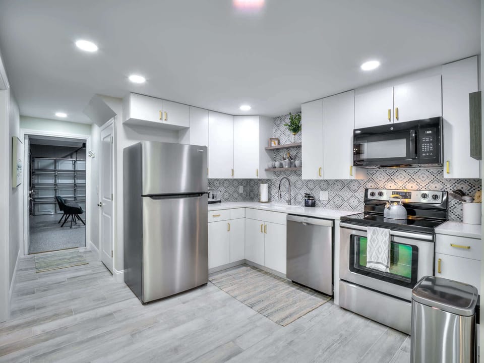 Kitchen with full size refrigerator, dishwasher, microwave and disposal 