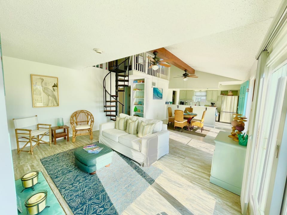 Living area with stairs to loft (office). 
