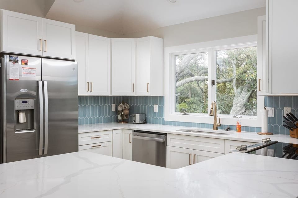 Fully Stocked Kitchen featuring breakfast seating, 3 coffee makers (Kenmore, Cuisinart and Keurig) and modern appliances (dishwasher, stove, oven, microwave, toaster, refrigerator, blender and much more)