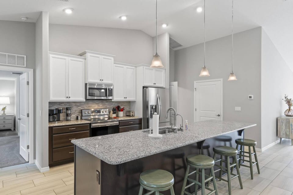 Bright and airy kitchen featuring essential amenities and countertop seating.