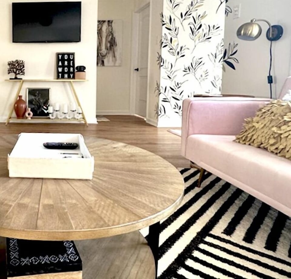 Step into a realm of comfort and creativity as you enter the welcoming front room of the Hartland Bungalow. This space is adorned with unique hand-painted artworks that invoke a sense of peace and creativity, setting a vibrant backdrop for your stay.