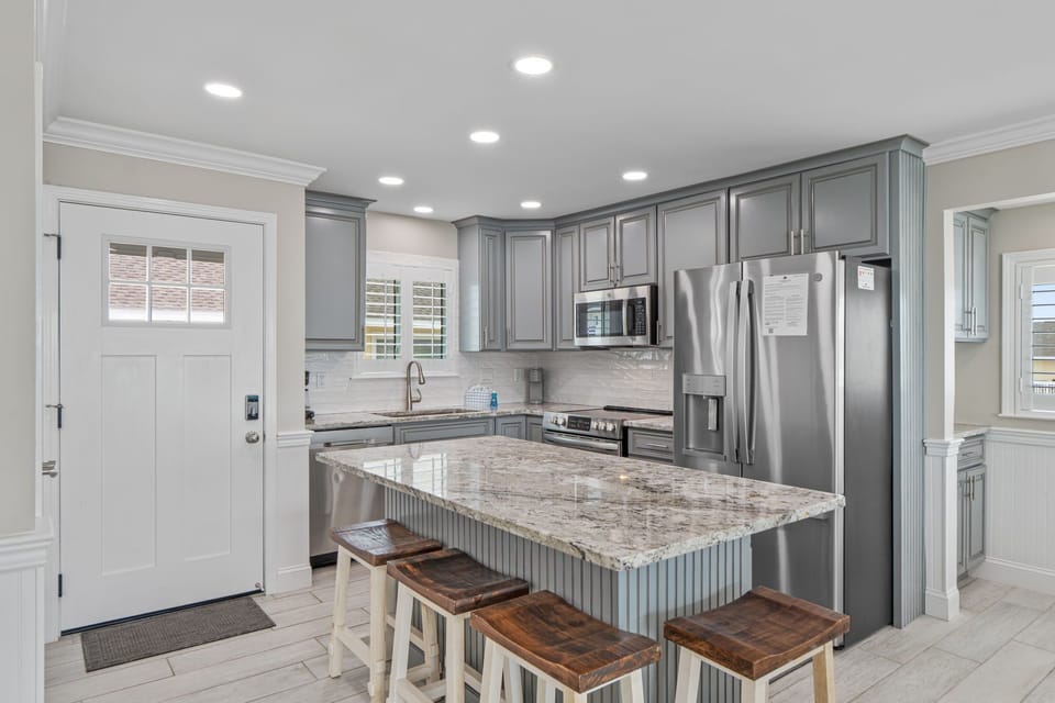 Your modern kitchen awaits with granite countertops, stainless steel appliances, and an island perfect for morning coffee or meal prep.