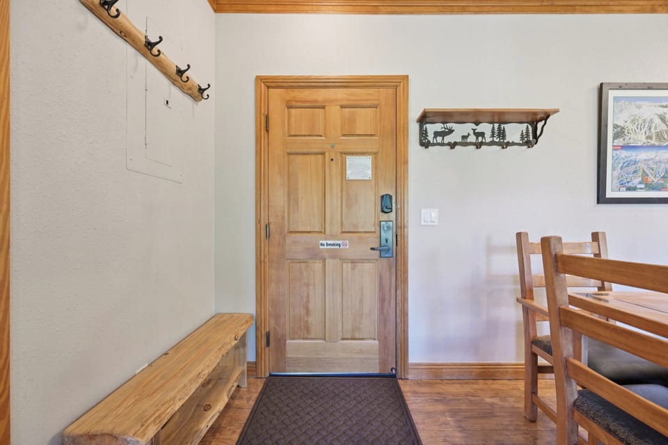 Step into your welcoming entryway with warm wood accents, convenient coat hooks, and a cozy bench for settling in after mountain adventures.