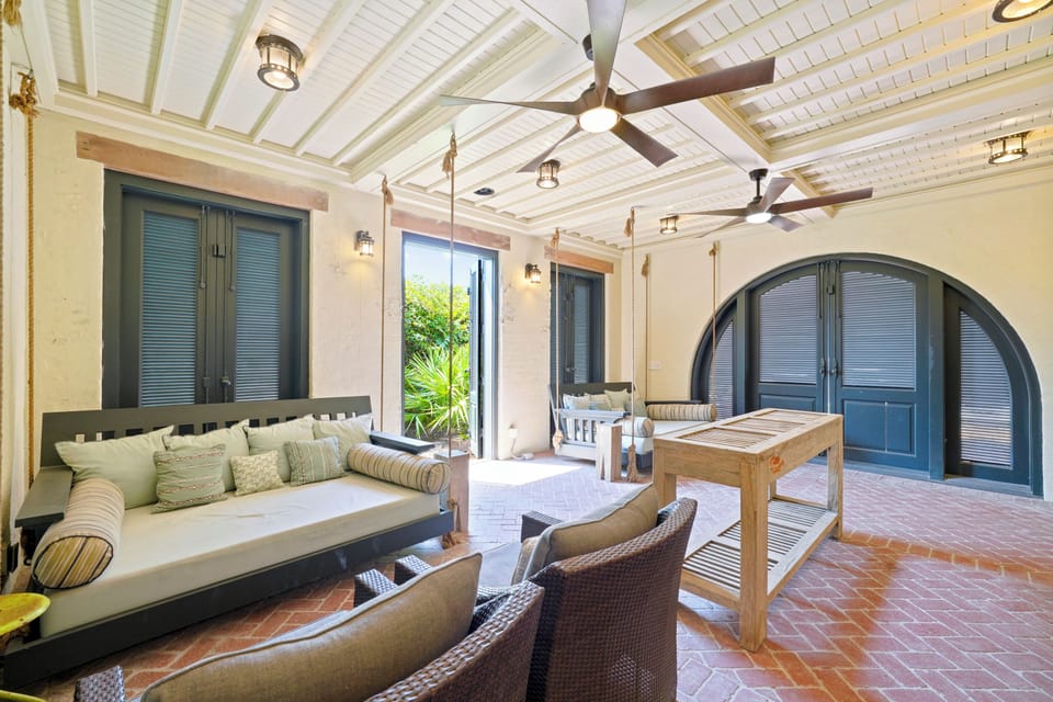 LOWER LEVEL FRONT PORCH LEADING RIGHT TO THE SAND