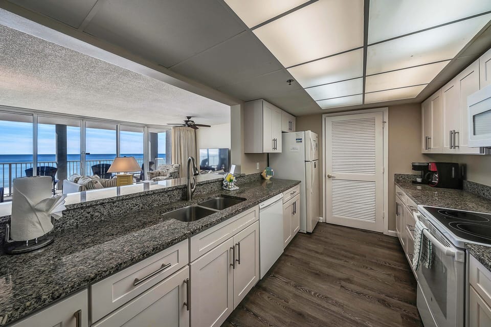 The fully equipped kitchen features granite countertops and has everything you need to prepare meals for family & friends.