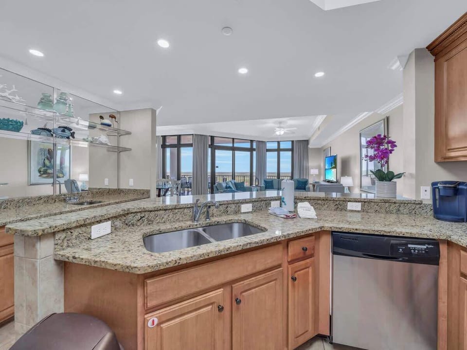 Fully equipped kitchen overlooks living room