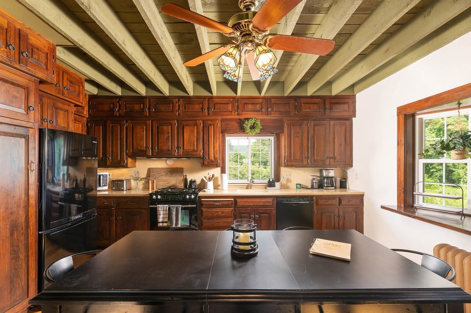 [Kitchen] Our eat-in kitchen is stocked with the essentials and then some.  The dining table can accommodate 8 guests.  We have card tables and chairs, if additional seating is desired.