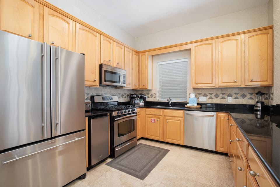 Your fully equipped kitchen features stainless steel appliances and granite counters, perfect for preparing meals with style and convenience.