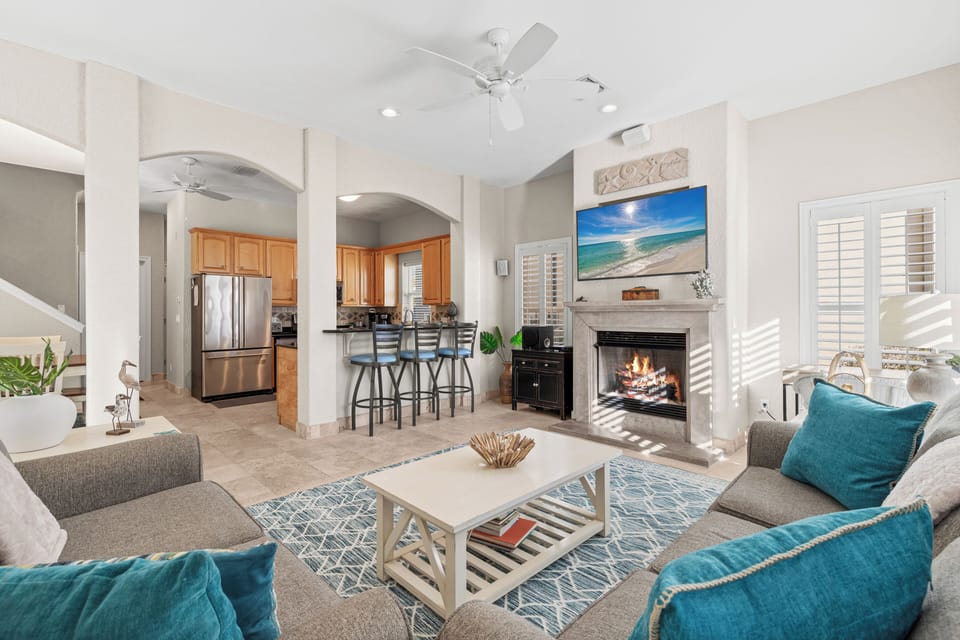 Sink into plush seating by your crackling fireplace while ocean views on the big screen complete your perfect beach house retreat.