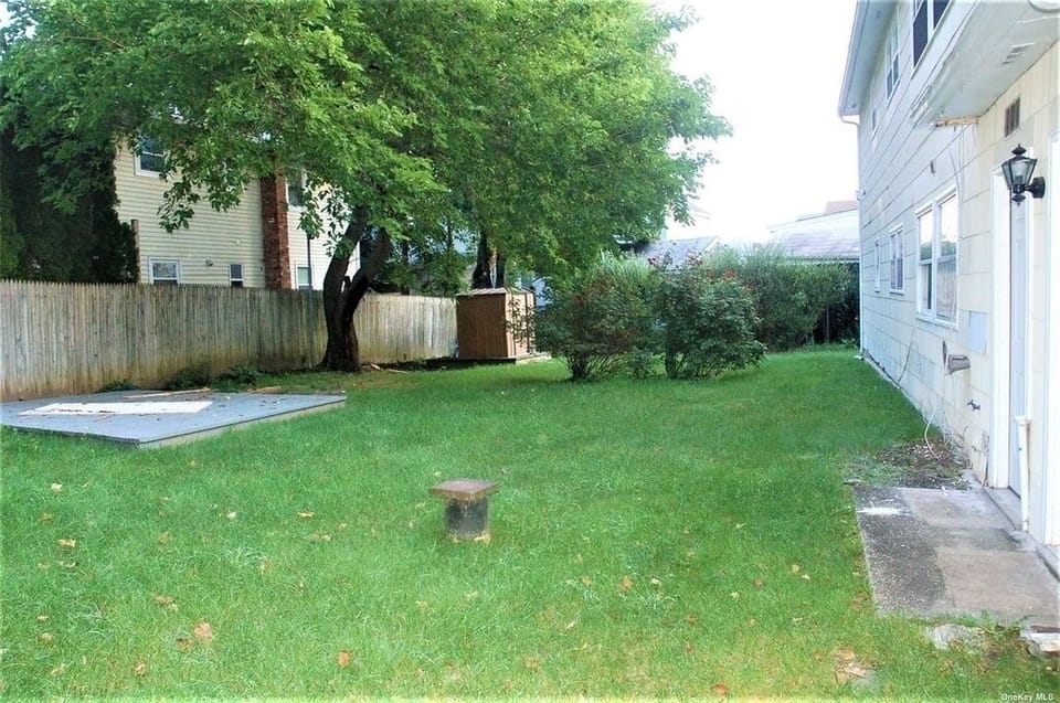 Large fenced in backyard with BBQ, canopy and furniture