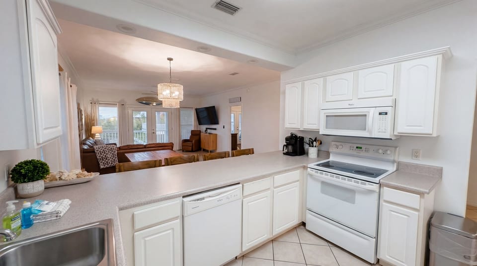 Bright, fully stocked kitchen with Keurig coffee maker, air-fryer and everything needed for easy meals at the beach.