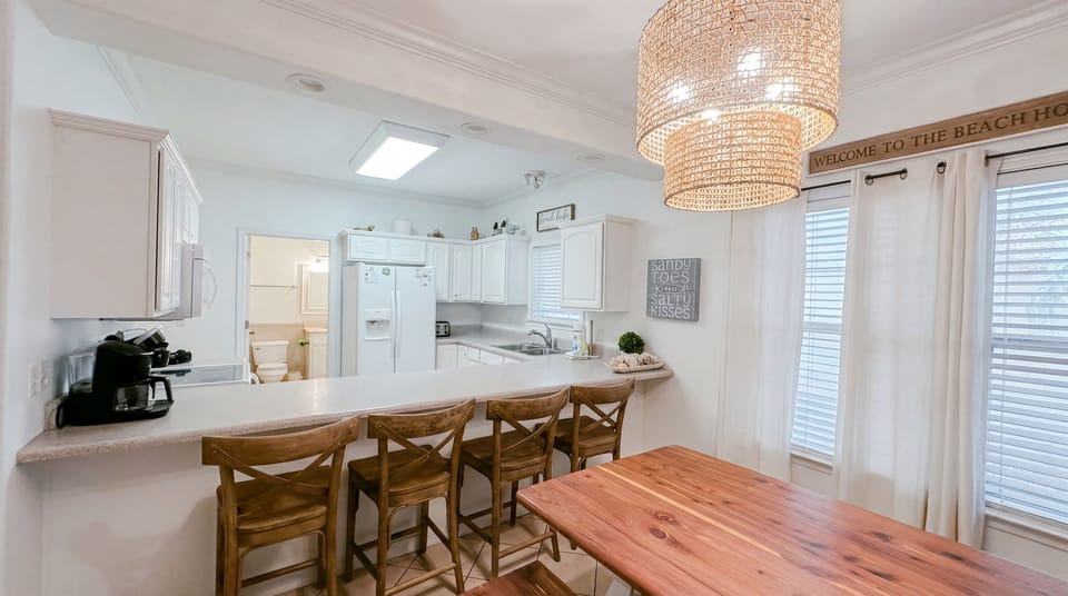 Bright and spacious living area with dining space for group meals and direct access to the private balcony.