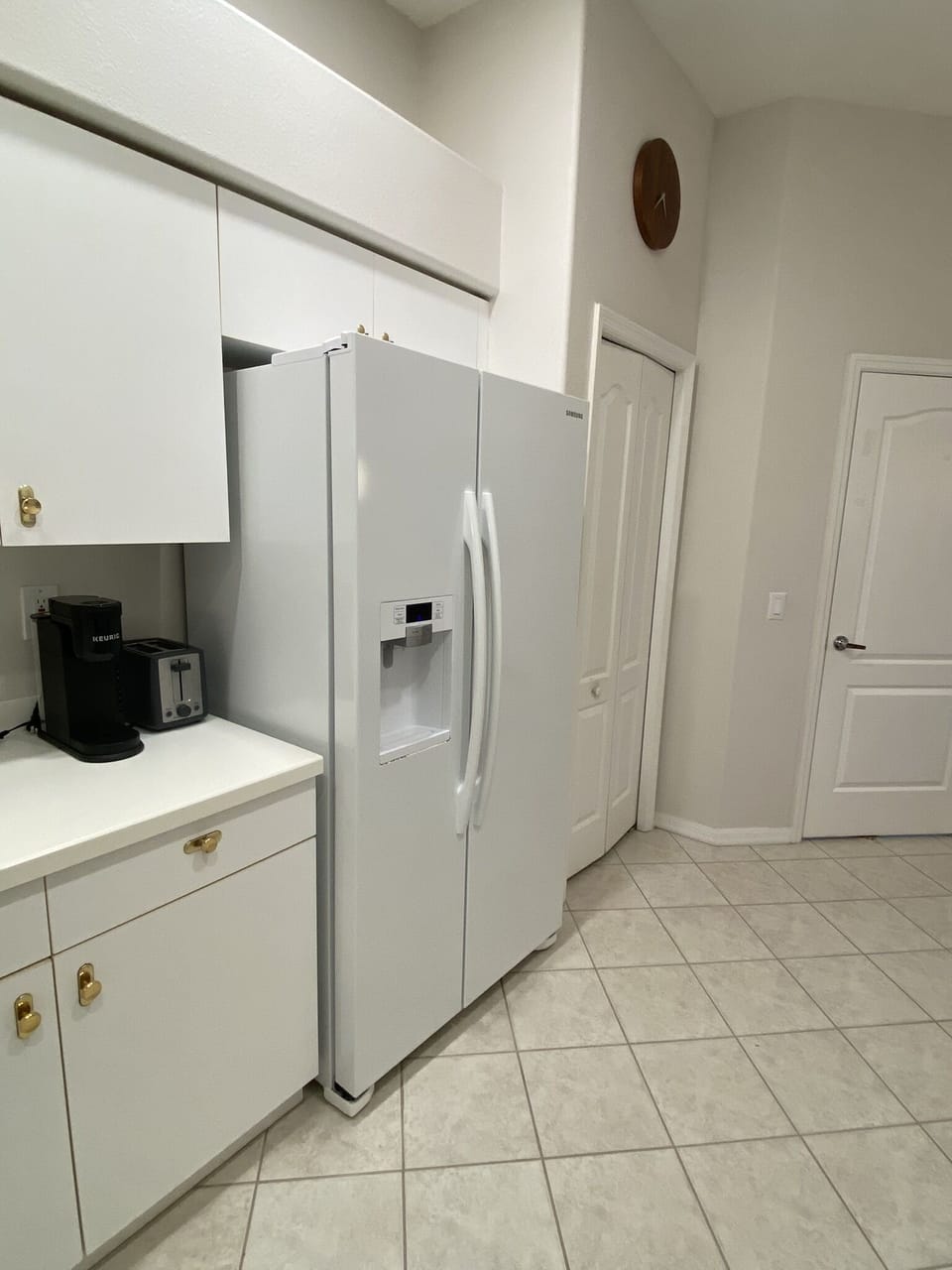 Kitchen, view from sink area towards laundry room and garage entrance.