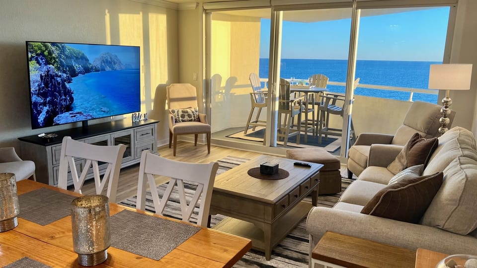 Open living space with direct Gulf views through expansive glass doors.