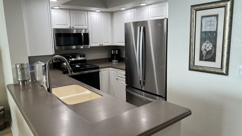 Fully equipped kitchen with stainless steel appliances.