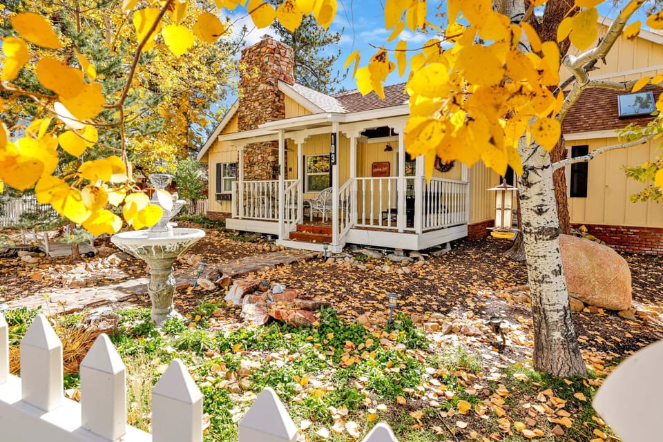 Welcoming cabin entry surrounded by towering pine trees, offering fresh mountain air and a peaceful forest setting—the perfect first impression for your Big Bear Lake getaway.