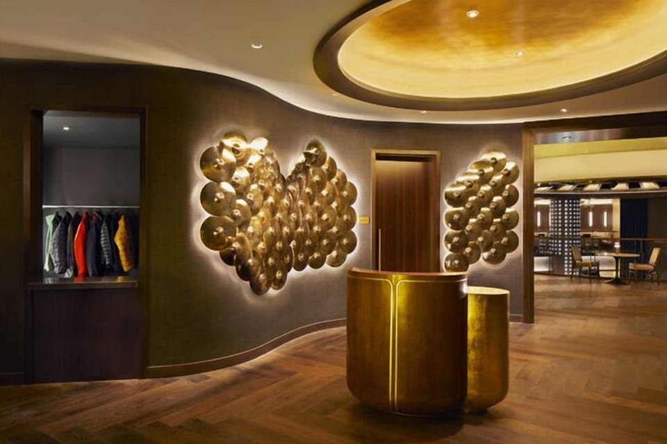 Step into a dramatic lobby with glowing sculptural art.