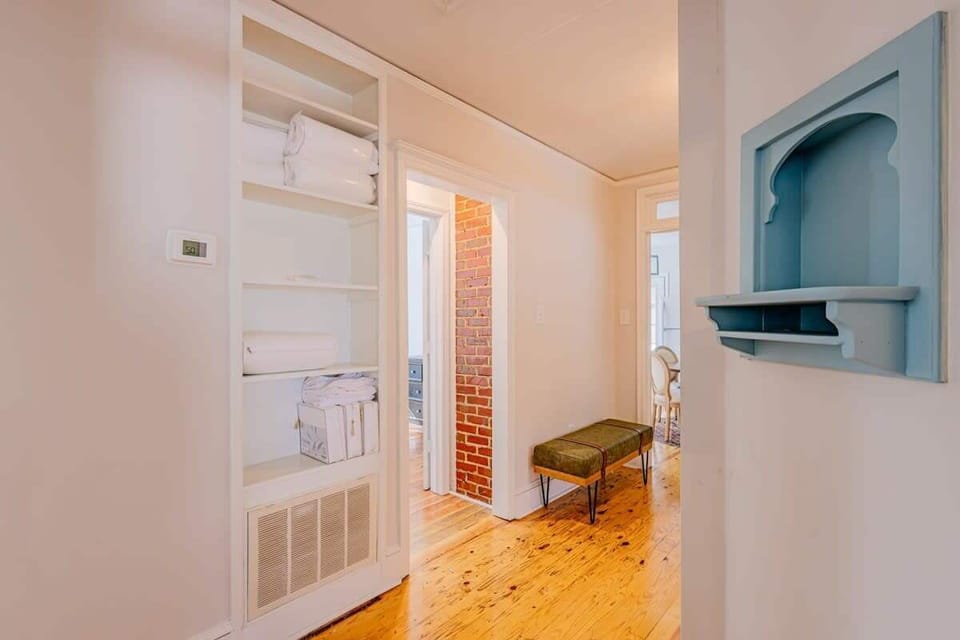 Bedroom to the left, kitchen straight ahead, and another bedroom to the right.