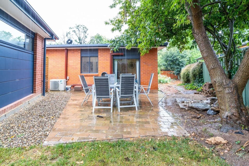 Spacious backyard with ample seating, perfect for enjoying outdoor gatherings and relaxing in the fresh air.