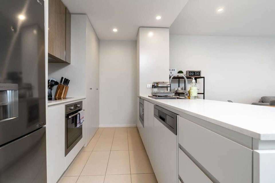 Step into our modern kitchen, featuring sleek appliances and a contemporary design. The clean lines and high-end finishes create a stylish and functional cooking space.