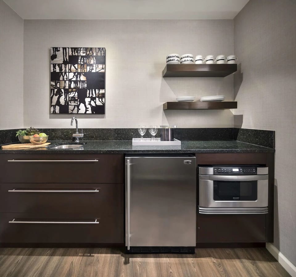 Prepare easy breakfasts on sleek counters with in-room kitchenette.