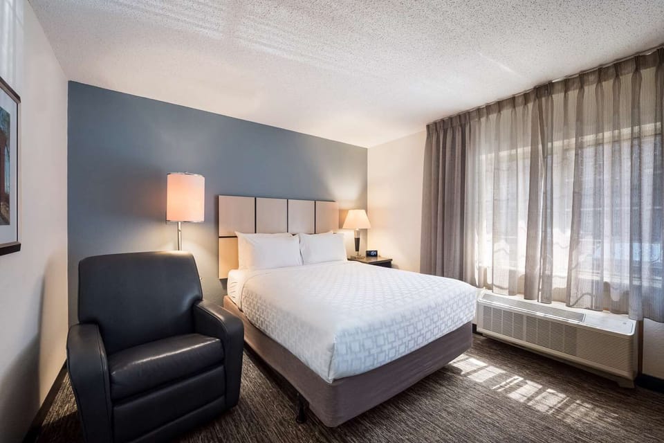 Sink into crisp linens and relax by the sunlit window.