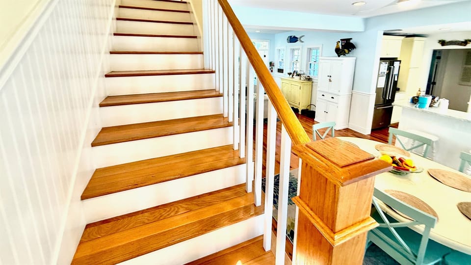 Accessible from the dining area, a staircase leads you to the two charming upstairs bedrooms, creating a seamless transition between the main living space and the private retreats above. 