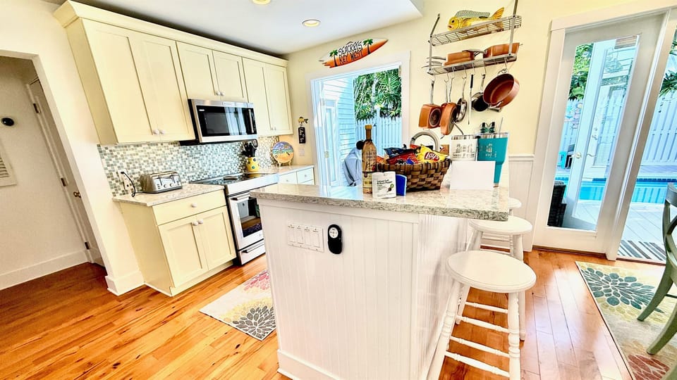 The island bar provides a perfect transition from the kitchen to the dining area