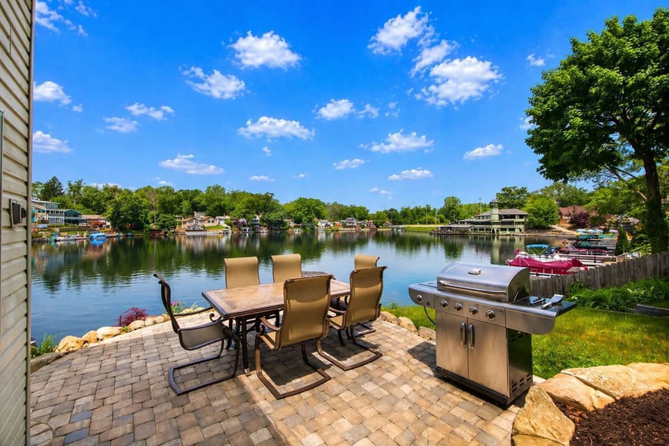 Outdoor patio w/ seating by the water, ideal for relaxing in the fresh air