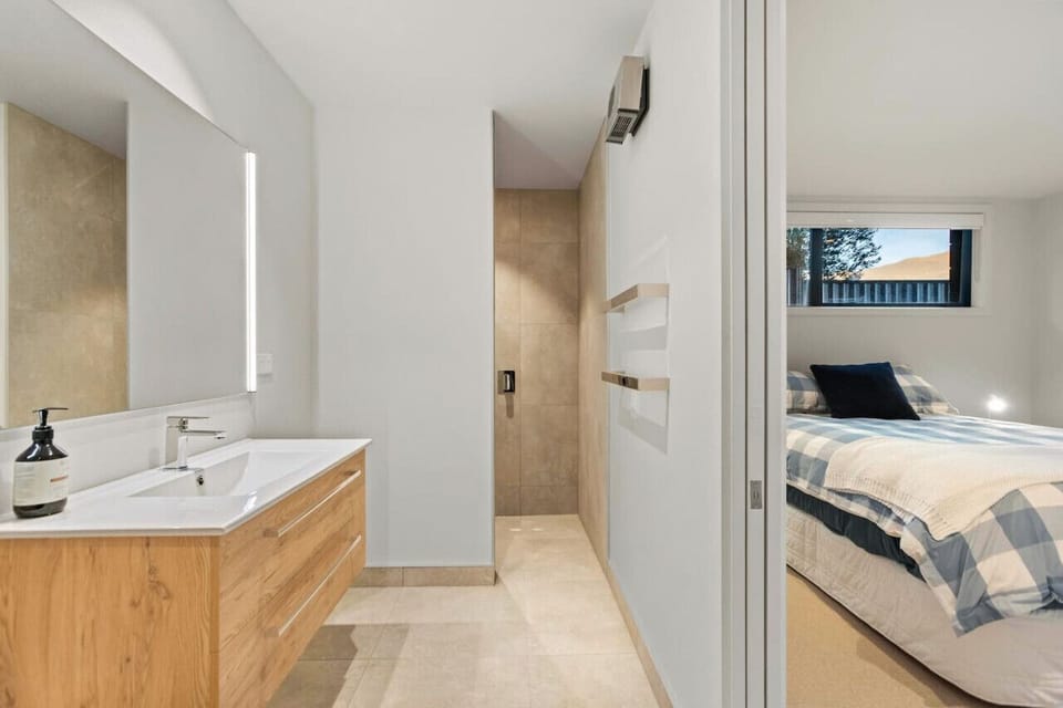 Modern ensuite bathroom with a shower, toilet, basin, and heater for your comfort.