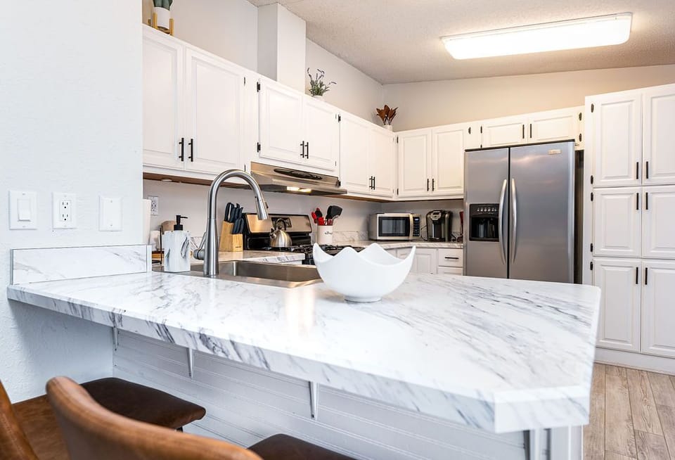Spacious kitchen w/ oversized island seating & bright open layout.