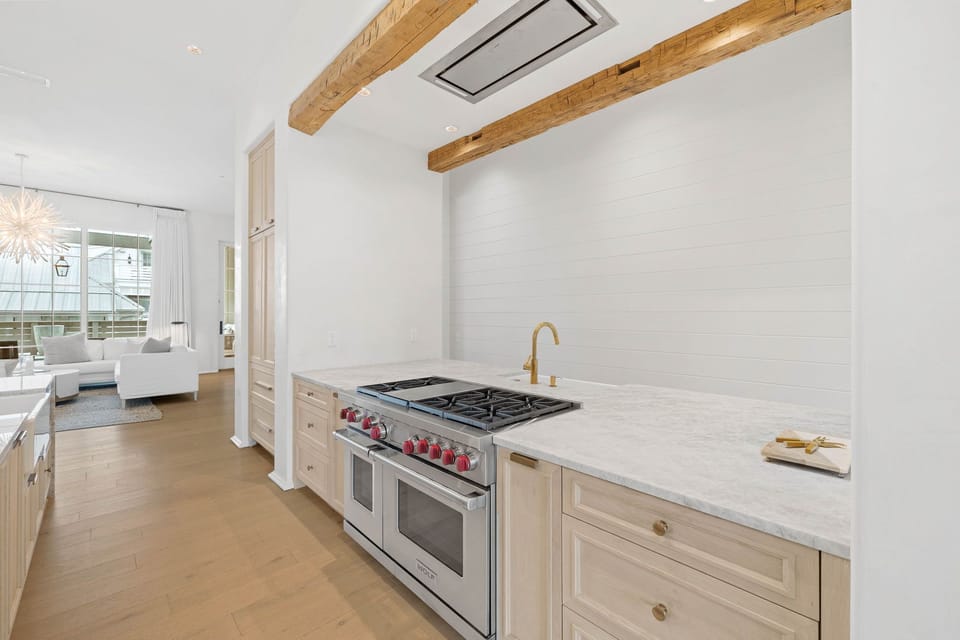 Kitchen Island with Butler Pantry, 3 Full Sized Kitchen sinks, 2 Dishwashers, Brass fixtures, Taj Mahal Quartz Countertops, Venetian Plaster Walls, European White Oak Counter Tops.