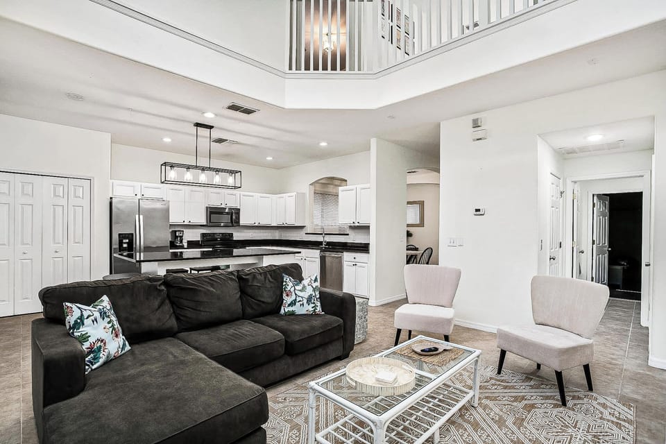 Experience comfort and style in this open-plan living area with modern kitchen, perfect for relaxing and entertaining.