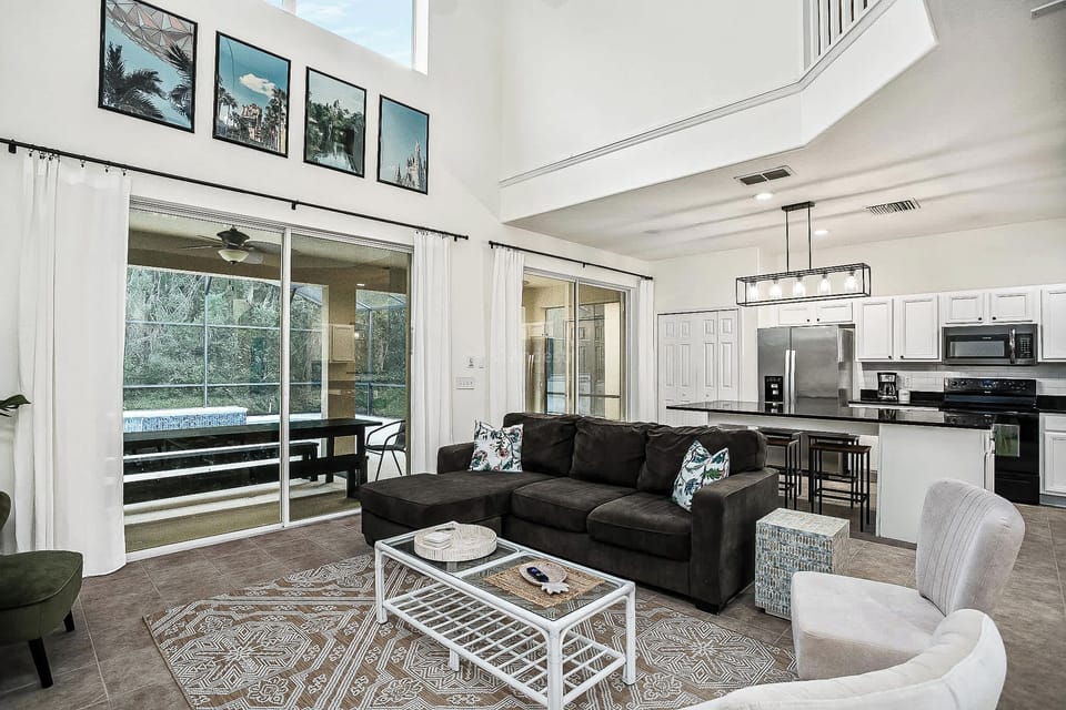 Spacious living area with modern kitchen and private patio access, perfect for relaxation and entertaining.