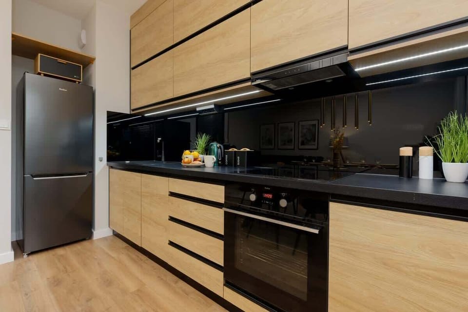 The sleek design of the kitchenette blending seamlessly with the living area.