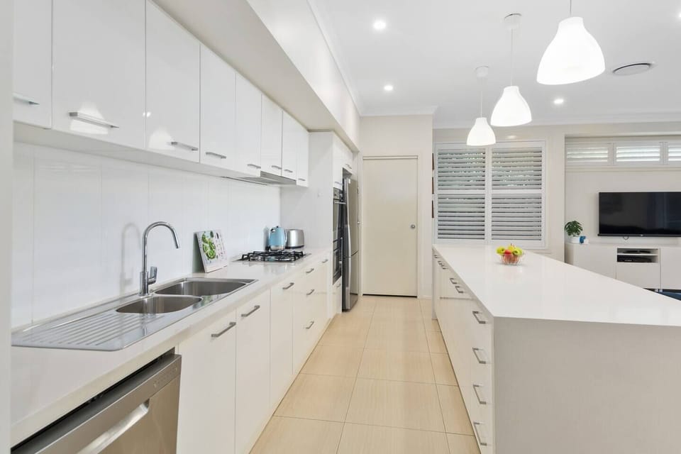 Cook meals with ease in the fully-equipped kitchen, offering ample bench space and premium appliances. 