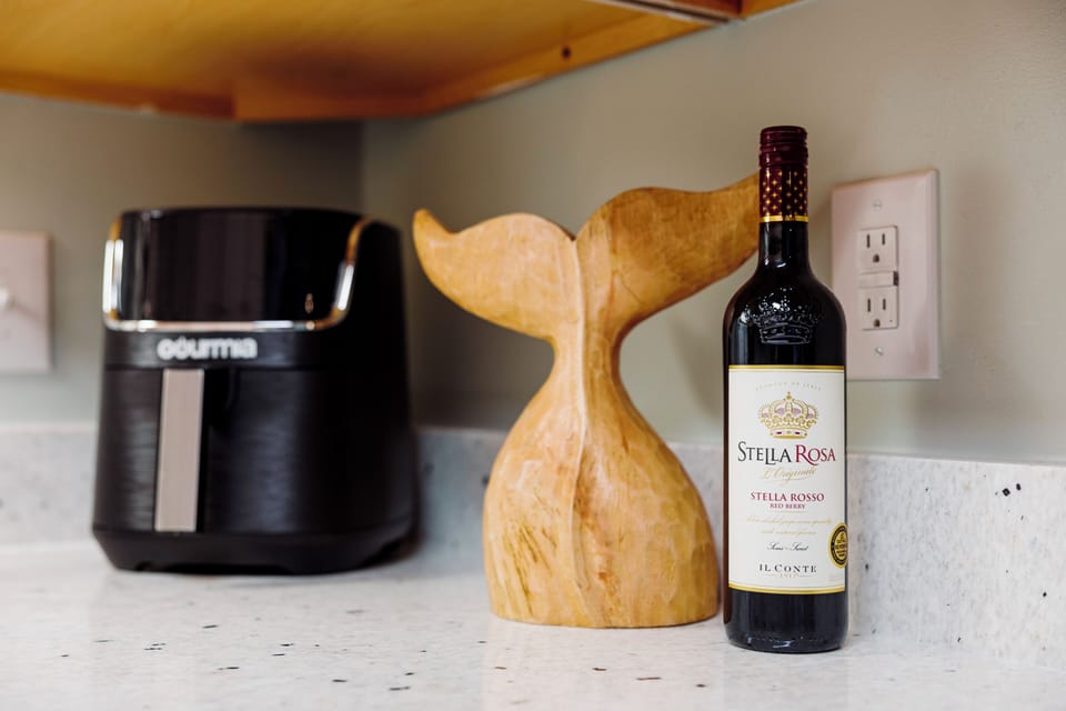 Your kitchen counter features thoughtful touches - fresh coffee brewing and wine ready for evening relaxation.