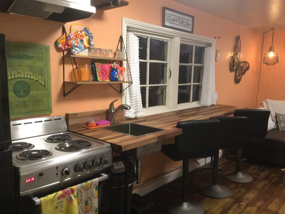 bar top, oven, fridge and pass threw windows to outside courtyard