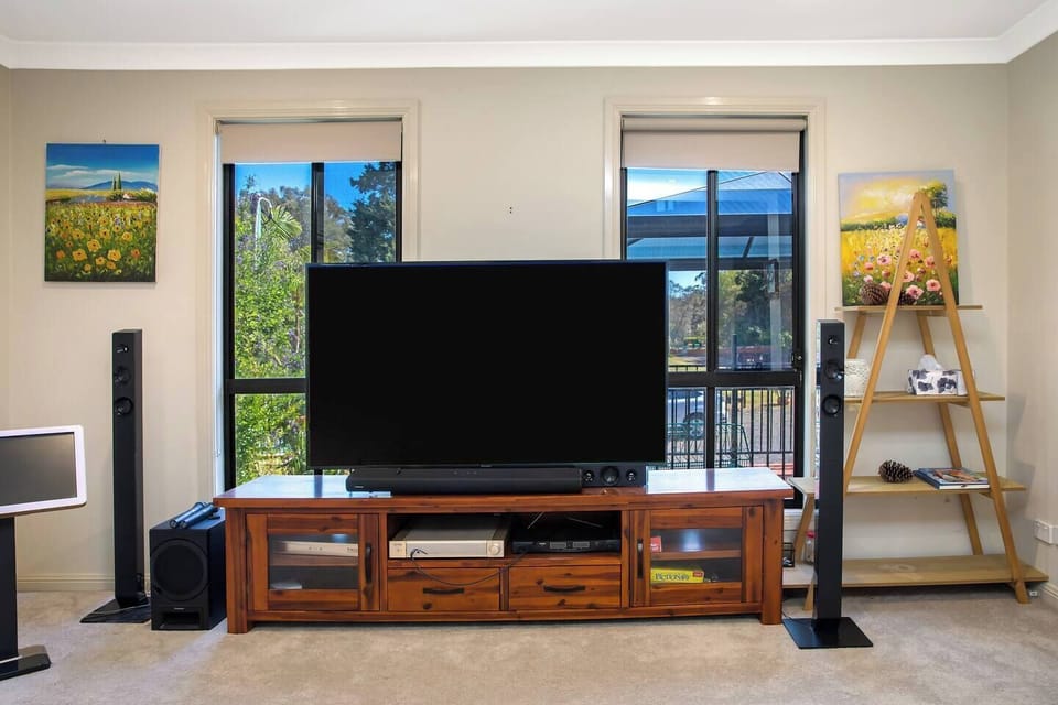 Relax and unwind in the lounge area with a cosy TV setup, ideal for catching up on your favourite shows or enjoying movie nights.