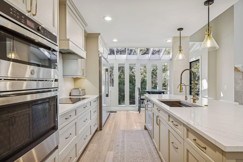 A gourmet experience awaits in the fully equipped kitchen featuring top-notch appliances, a wine cooler, and a formal dining area for group meals