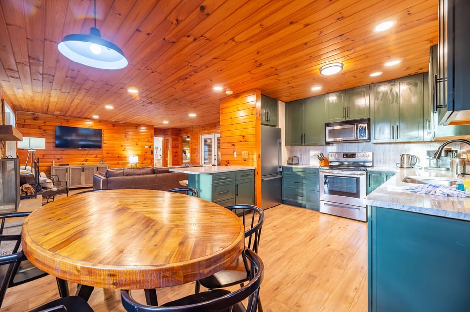 modern eat in kitchen with stone counters, stainless appliances 
