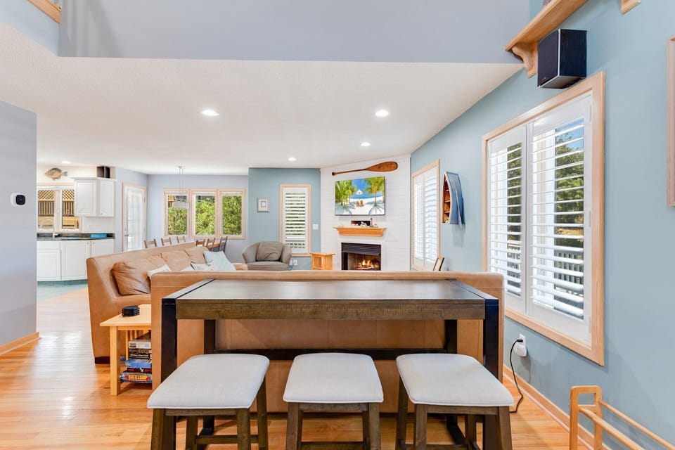Enter on the Main Level where you'll find a spacious Living Area with comfortable furniture, a large Flat Screen TV, and an electric Fireplace waiting for you.