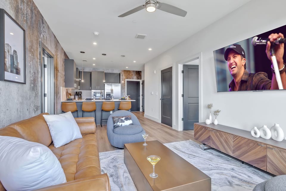 Bright living room with comfortable seating, smart TV, designer decor, and access to the private patio.